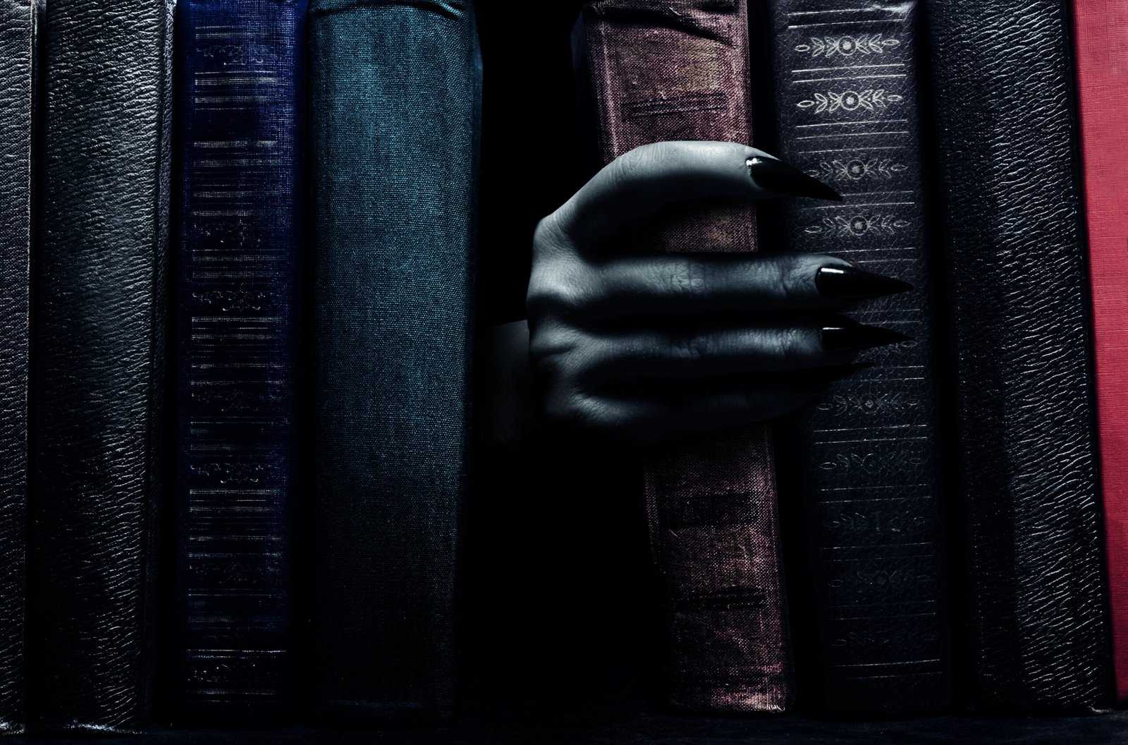 Hand coming out of books